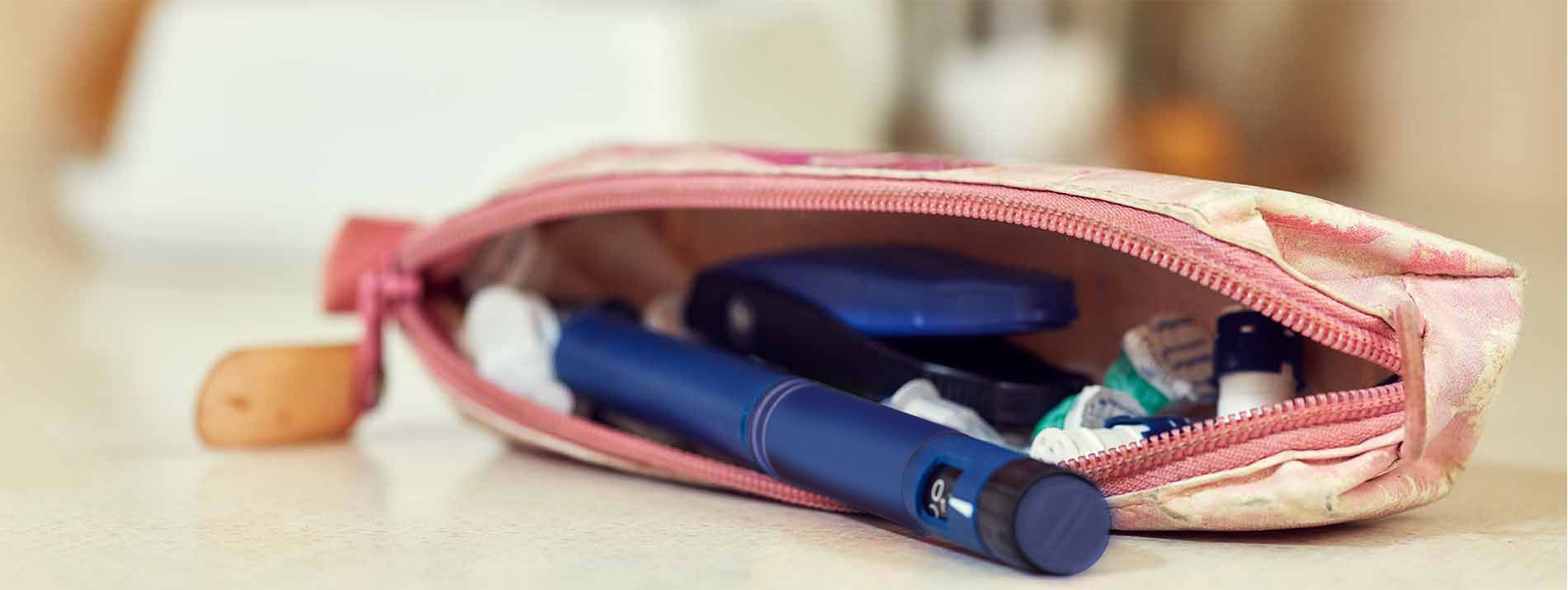 Sac à main posé sur une table, un FlexPen orange en sort.