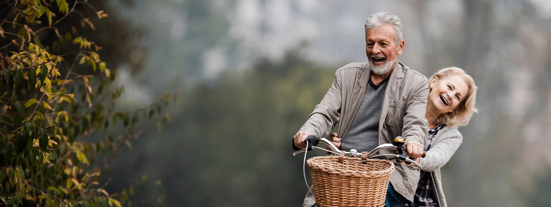 Woman biking in a street with flowers in the background.