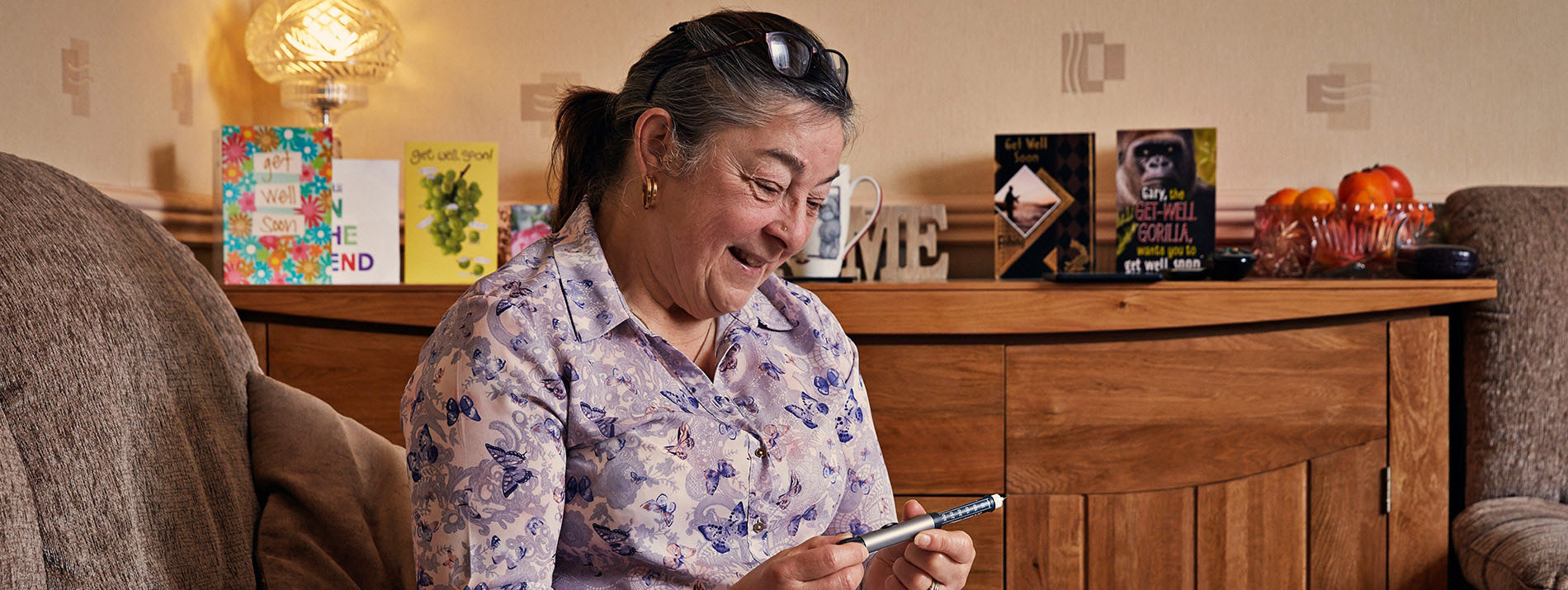 Smiling woman holding a NovoPen 5
